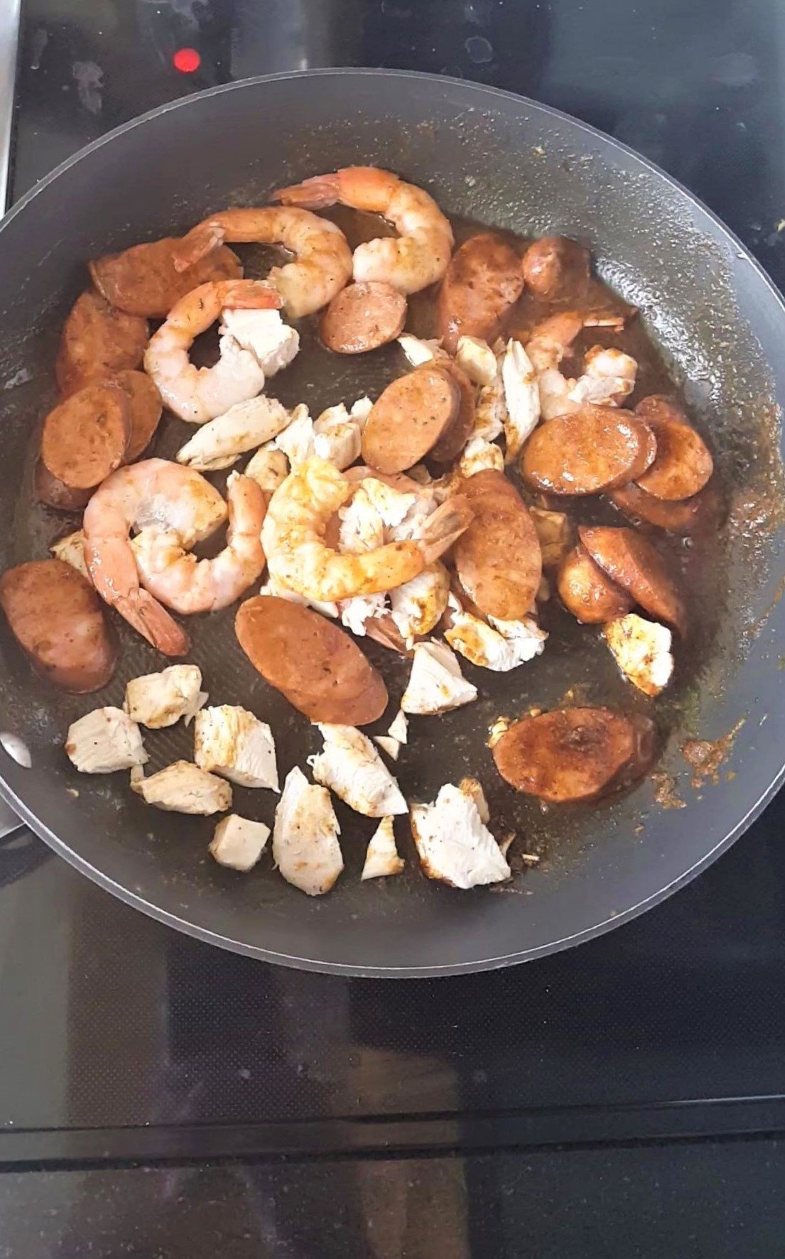 Pan of sausage, chicken, shrimp frying